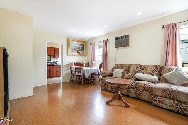 15207 Lorne St, Panorama City, CA 91402 - living room featuring a wall unit AC, light wood-type flooring, and recessed lighting