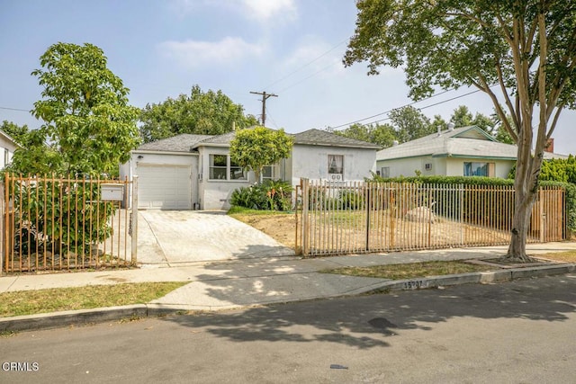 15207 Lorne St, Panorama City, CA 91402 - view of front facade with a fenced front yard, driveway, stucco siding, and an attached garage