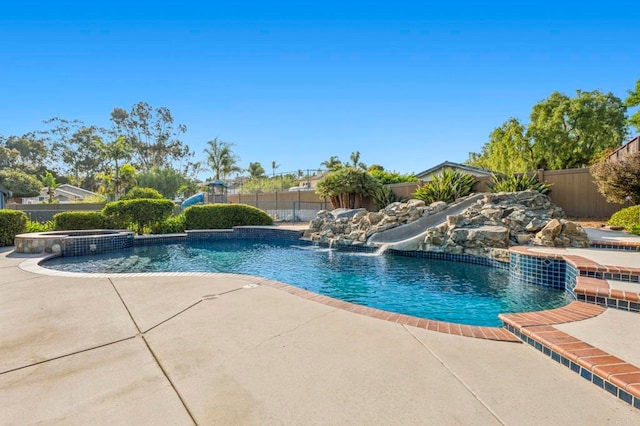 525 Hilo Way, Vista, CA 92081 - view of swimming pool featuring a fenced backyard, a water slide, a patio, and a pool with connected hot tub