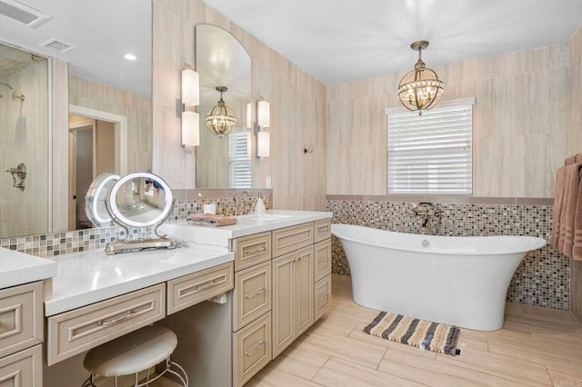 525 Hilo Way, Vista, CA 92081 - full bathroom featuring a chandelier, tile walls, a soaking tub, vanity, and tasteful backsplash