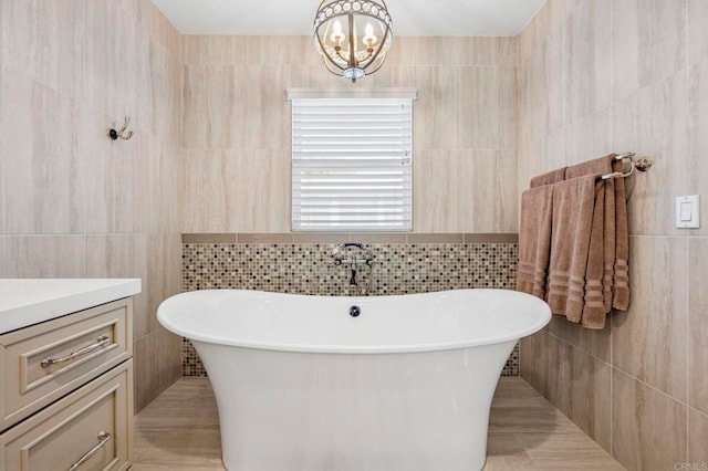 525 Hilo Way, Vista, CA 92081 - full bath featuring tile walls, a soaking tub, vanity, and a chandelier