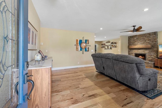 525 Hilo Way, Vista, CA 92081 - living room with light wood-style floors, a ceiling fan, a fireplace, and recessed lighting