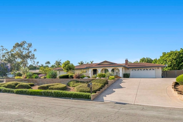 525 Hilo Way, Vista, CA 92081 - view of front facade featuring concrete driveway, a chimney, a garage, stucco siding, and a tile roof