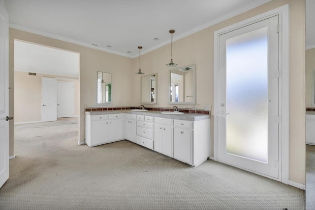 1138 Via Mil Cumbres, Solana Beach, CA 92075 - kitchen with light colored carpet, white cabinetry, crown molding, pendant lighting, and light countertops