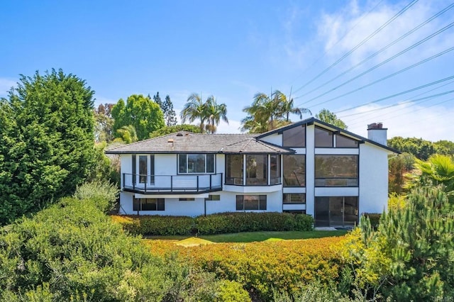 1138 Via Mil Cumbres, Solana Beach, CA 92075 - rear view of house featuring stucco siding, a sunroom, and a chimney