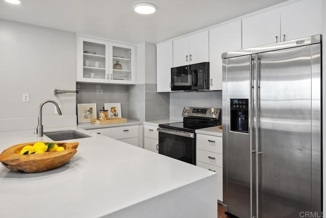 2500 Torrey Pines Rd Unit 1202, La Jolla, CA 92037 - kitchen featuring stainless steel appliances, glass insert cabinets, light countertops, white cabinets, and recessed lighting