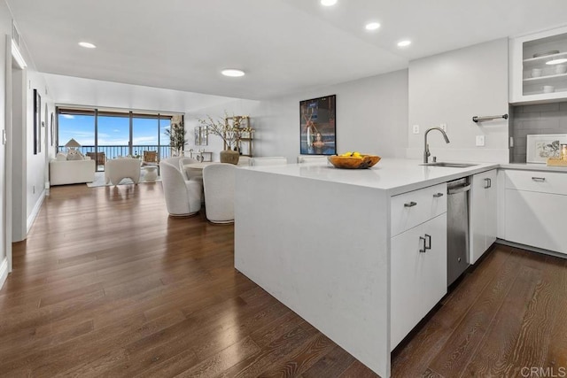 2500 Torrey Pines Rd Unit 1202, La Jolla, CA 92037 - kitchen with a peninsula, dishwasher, light countertops, dark wood-style floors, and white cabinetry