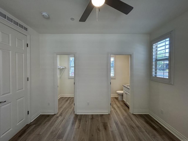35909 Shetland Hls E, Fallbrook, CA 92028 - unfurnished bedroom featuring wood finished floors, a walk in closet, ensuite bath, and ceiling fan