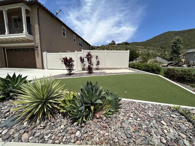 35909 Shetland Hls E, Fallbrook, CA 92028 - view of yard with a mountain view, an attached garage, concrete driveway, and a balcony