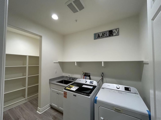 35909 Shetland Hls E, Fallbrook, CA 92028 - laundry room with cabinet space, washer and clothes dryer, wood finished floors, and recessed lighting