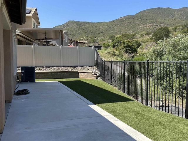 35909 Shetland Hls E, Fallbrook, CA 92028 - fenced backyard with ceiling fan, a mountain view, and a patio area