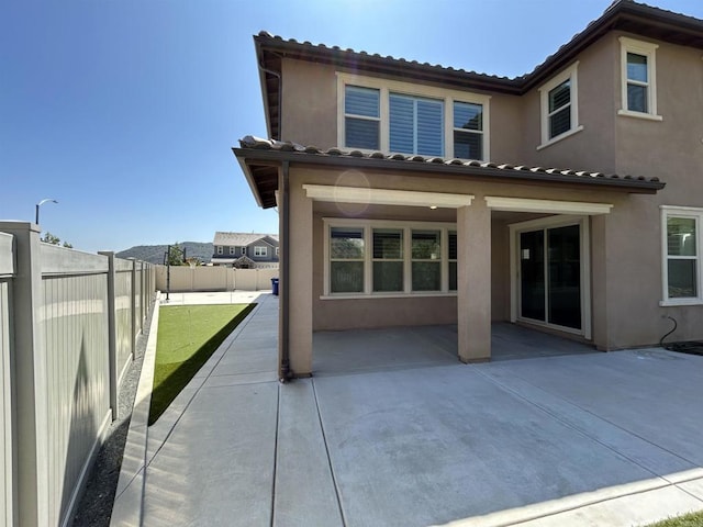 35909 Shetland Hls E, Fallbrook, CA 92028 - back of property with a patio, stucco siding, a fenced backyard, and a tile roof