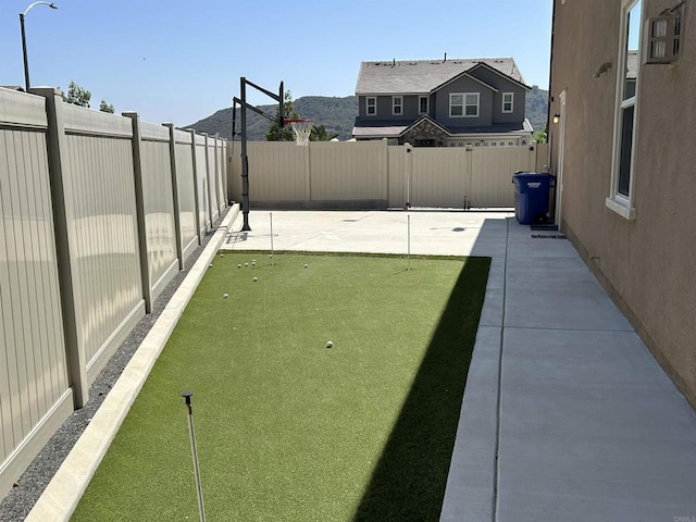 35909 Shetland Hls E, Fallbrook, CA 92028 - fenced backyard with a patio and a putting area