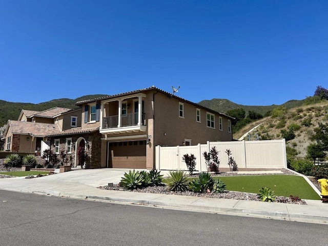 35909 Shetland Hls E, Fallbrook, CA 92028 - mediterranean / spanish home with a mountain view, an attached garage, a balcony, and stucco siding