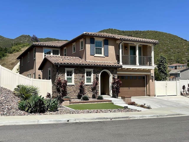 35909 Shetland Hls E, Fallbrook, CA 92028 - mediterranean / spanish house featuring a mountain view, an attached garage, a tiled roof, stucco siding, and driveway