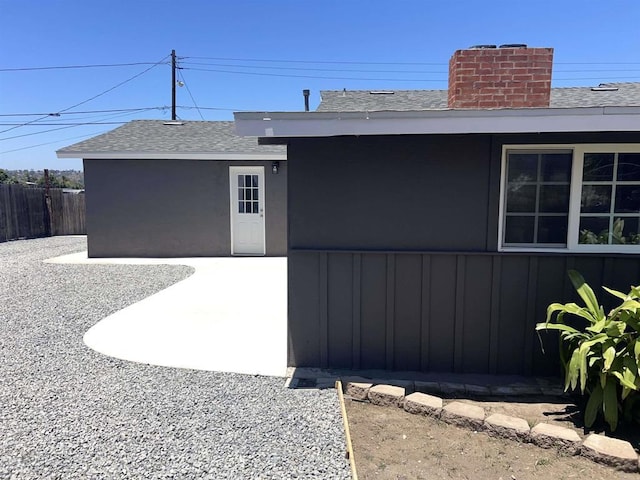 633 Kempton, Spring Valley, CA 91977 - doorway to property featuring roof with shingles, a chimney, and a patio