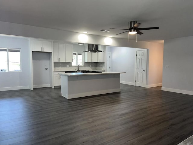 633 Kempton, Spring Valley, CA 91977 - kitchen featuring wall chimney range hood, white cabinetry, dark wood-type flooring, light countertops, and a ceiling fan