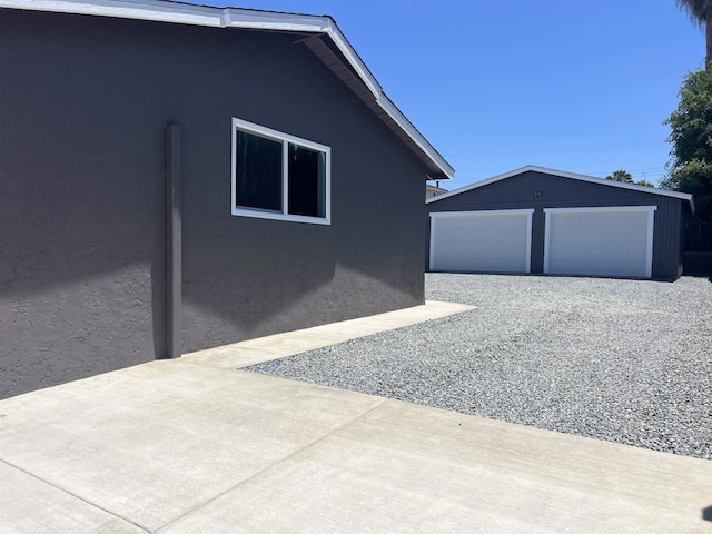 633 Kempton, Spring Valley, CA 91977 - view of home's exterior with an outbuilding, a detached garage, and stucco siding