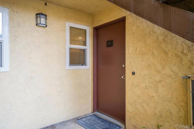 5910 Rancho Mission Rd Unit 37, San Diego, CA 92108 - doorway to property with stucco siding