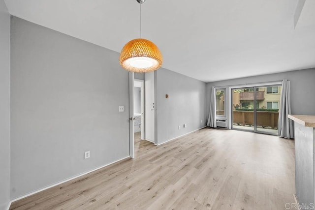 5910 Rancho Mission Rd Unit 37, San Diego, CA 92108 - unfurnished living room with light wood-type flooring and a wall unit AC