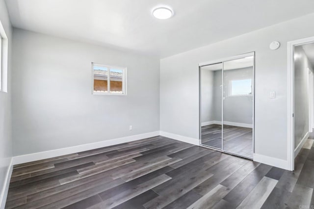 1947 D Ave, National City, CA 91950 - unfurnished bedroom with a closet and dark wood finished floors