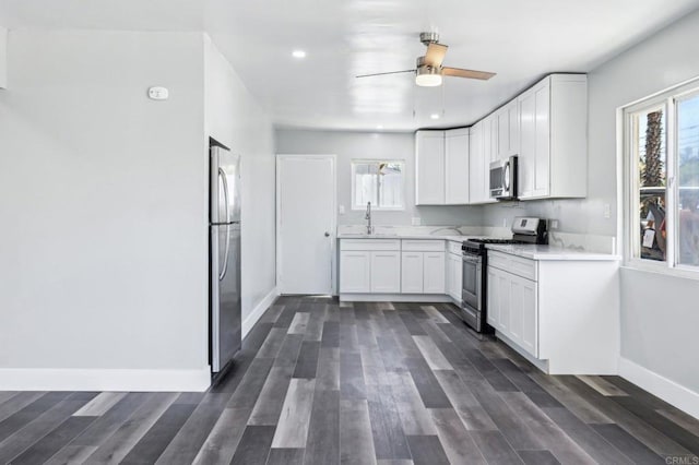 1947 D Ave, National City, CA 91950 - kitchen with stainless steel appliances, white cabinetry, dark wood-style floors, ceiling fan, and recessed lighting