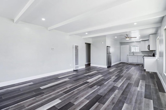 1947 D Ave, National City, CA 91950 - unfurnished living room with a heating unit, beam ceiling, dark wood finished floors, recessed lighting, and a ceiling fan