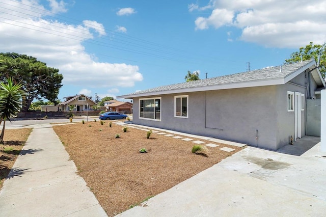 1947 D Ave, National City, CA 91950 - view of property exterior featuring stucco siding, a shingled roof, and a patio area