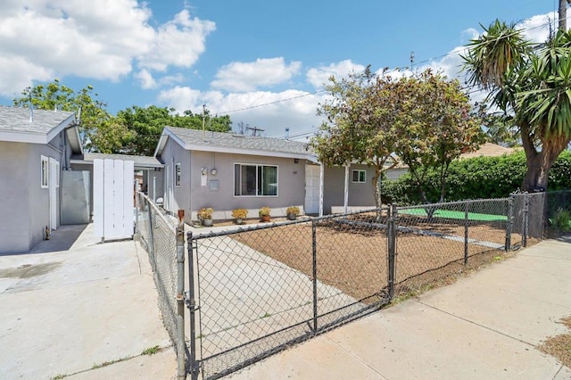 1947 D Ave, National City, CA 91950 - view of front of home with a fenced front yard, stucco siding, and a gate