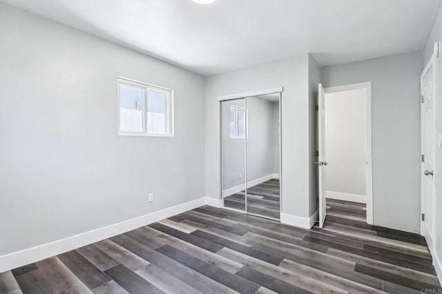 1947 D Ave, National City, CA 91950 - unfurnished bedroom featuring a closet and dark wood-style flooring