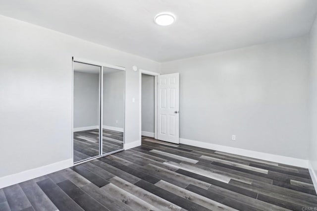 1947 D Ave, National City, CA 91950 - unfurnished bedroom with dark wood-style flooring and a closet