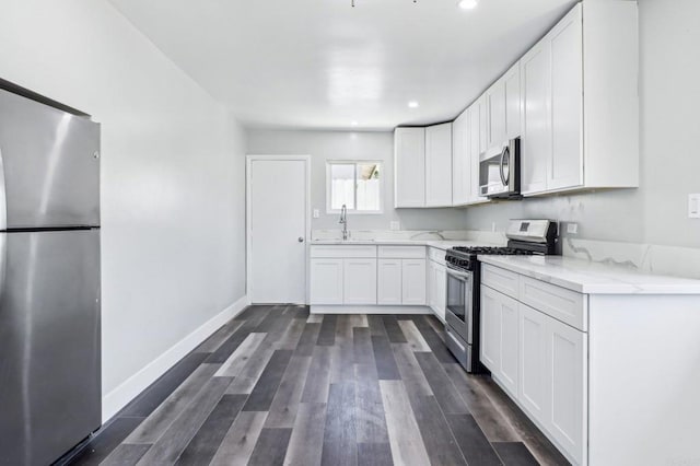 1947 D Ave, National City, CA 91950 - kitchen featuring appliances with stainless steel finishes, light stone countertops, white cabinetry, and recessed lighting