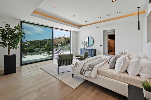 6627 Muirlands Dr, La Jolla, CA 92037 - bedroom with access to outside, a raised ceiling, expansive windows, and light wood-style floors