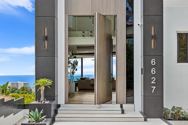 6627 Muirlands Dr, La Jolla, CA 92037 - view of exterior entry with a water view and stucco siding