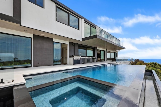 6627 Muirlands Dr, La Jolla, CA 92037 - view of pool with exterior kitchen, an in-ground hot tub, an infinity pool, and a patio area
