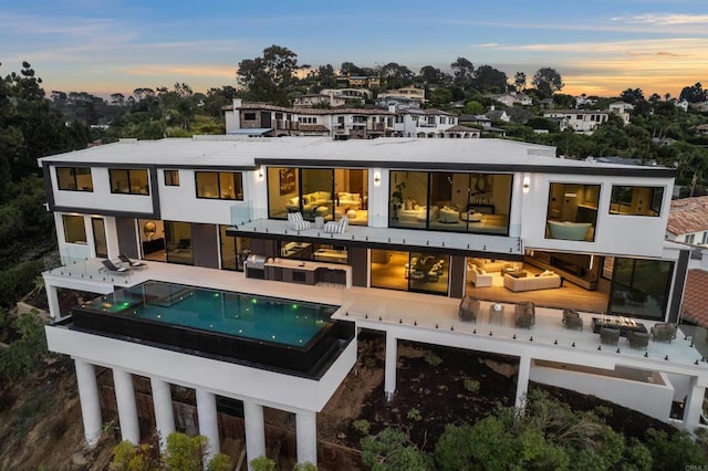 6627 Muirlands Dr, La Jolla, CA 92037 - rear view of house featuring an outdoor pool and a patio