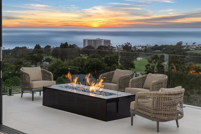 6627 Muirlands Dr, La Jolla, CA 92037 - patio terrace at dusk featuring an outdoor fire pit, a water view, and a patio area