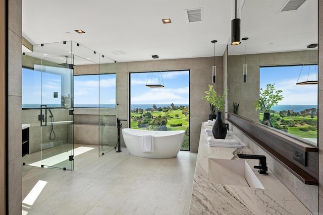 6627 Muirlands Dr, La Jolla, CA 92037 - bathroom with a shower stall, a soaking tub, plenty of natural light, vanity, and tile walls