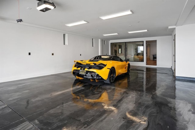 6627 Muirlands Dr, La Jolla, CA 92037 - garage with a garage door opener and baseboards