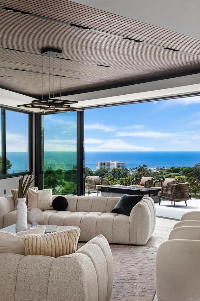 6627 Muirlands Dr, La Jolla, CA 92037 - living area featuring wood finished floors, healthy amount of natural light, and a water view