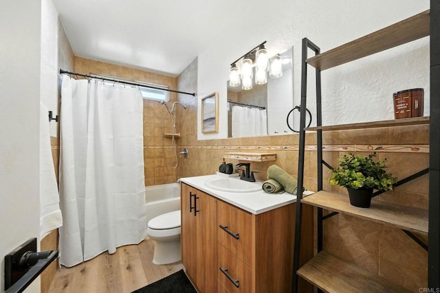 1472 Loma Ln, Chula Vista, CA 91911 - full bathroom with vanity, wood finished floors, shower / bath combo with shower curtain, and tile walls