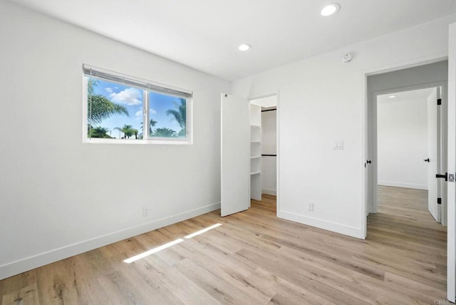 1472 Loma Ln, Chula Vista, CA 91911 - unfurnished bedroom featuring light wood-style flooring, recessed lighting, and a walk in closet