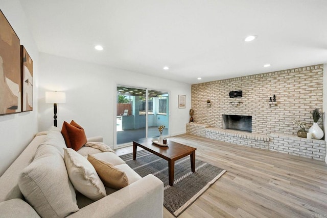 1472 Loma Ln, Chula Vista, CA 91911 - living room with wood finished floors, brick wall, recessed lighting, and a brick fireplace