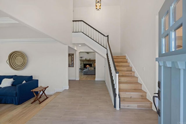 18 Gateview Dr, Fallbrook, CA 92028 - foyer entrance featuring a towering ceiling, stairway, and a lit fireplace