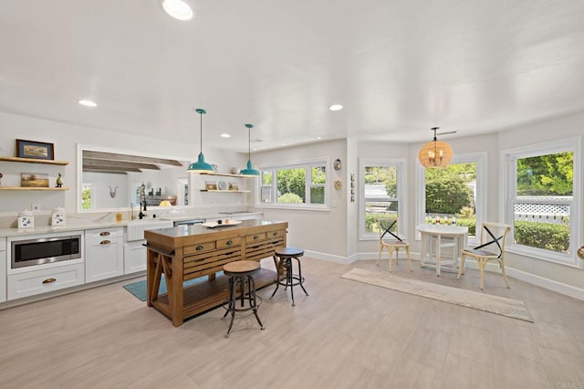 18 Gateview Dr, Fallbrook, CA 92028 - kitchen featuring stainless steel microwave, open shelves, light countertops, recessed lighting, and white cabinets