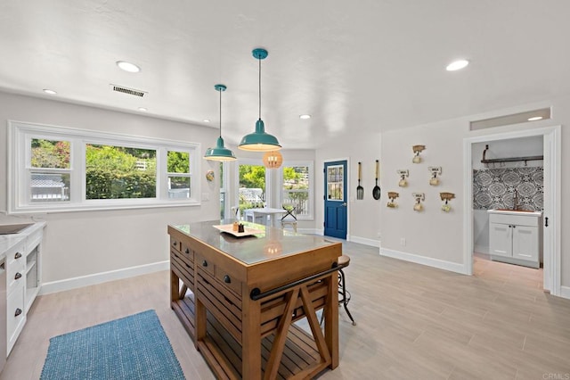 18 Gateview Dr, Fallbrook, CA 92028 - kitchen with healthy amount of natural light, recessed lighting, hanging light fixtures, light wood-type flooring, and white cabinetry