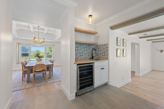 18 Gateview Dr, Fallbrook, CA 92028 - indoor wet bar with beverage cooler, light wood-type flooring, beam ceiling, a chandelier, and crown molding