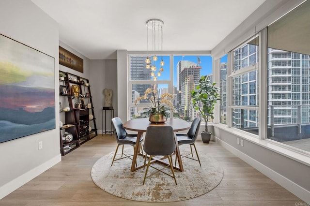 1325 Pacific Hwy Unit 1004, San Diego, CA 92101 - dining area with plenty of natural light, a city view, wood finished floors, and a chandelier