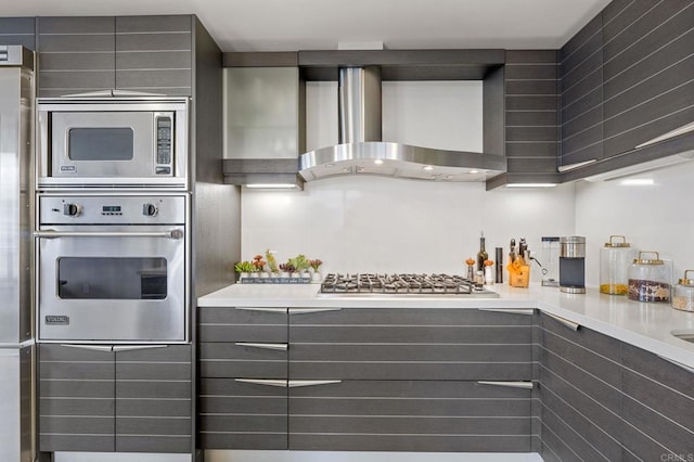 1325 Pacific Hwy Unit 1004, San Diego, CA 92101 - kitchen featuring stainless steel appliances, wall chimney exhaust hood, gray cabinets, and light countertops
