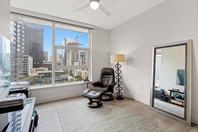 1325 Pacific Hwy Unit 1004, San Diego, CA 92101 - sitting room featuring healthy amount of natural light, wood finished floors, a city view, and ceiling fan